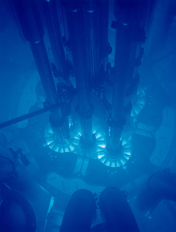Picture is a photograph of the blue glow in a reactor pool.